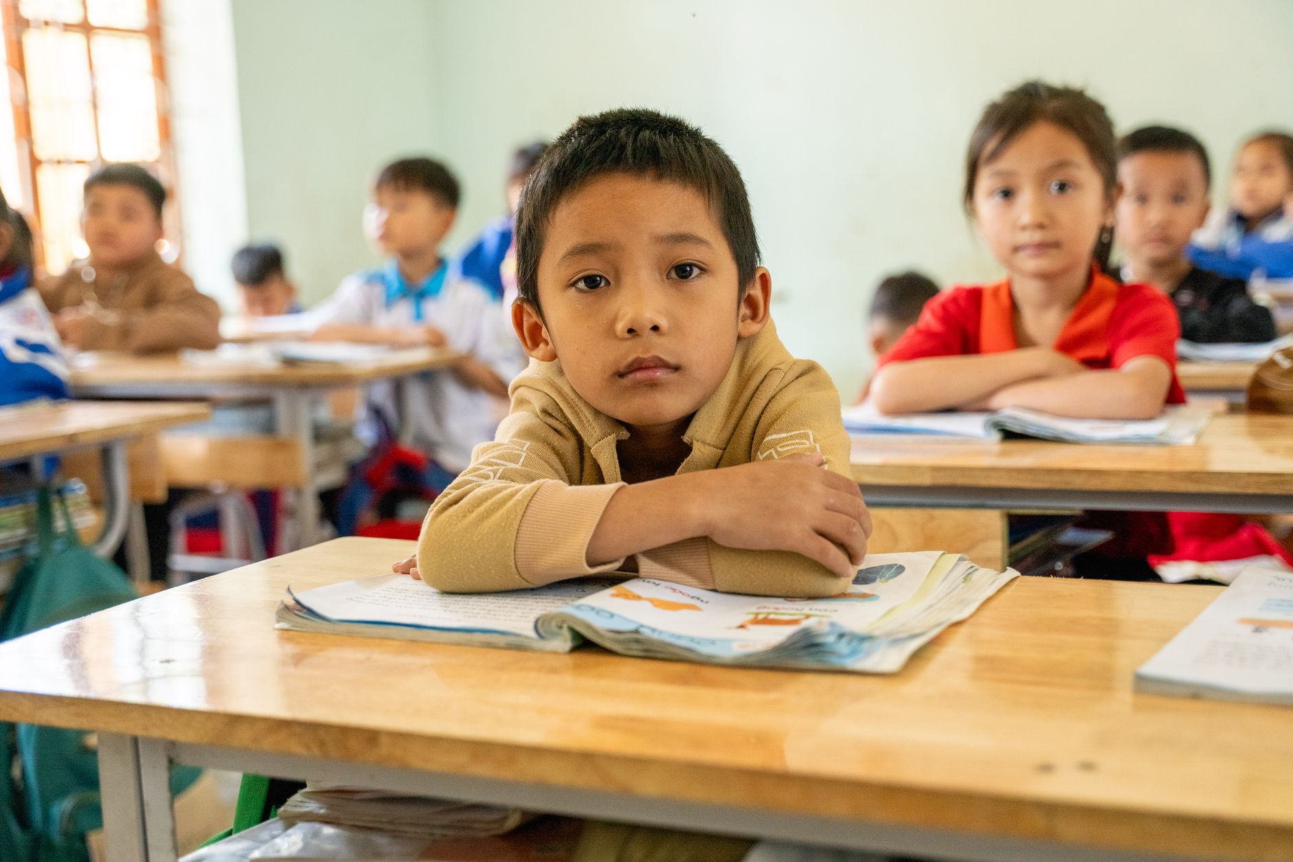 A group of attentive children learning in an interactive classroom environment.